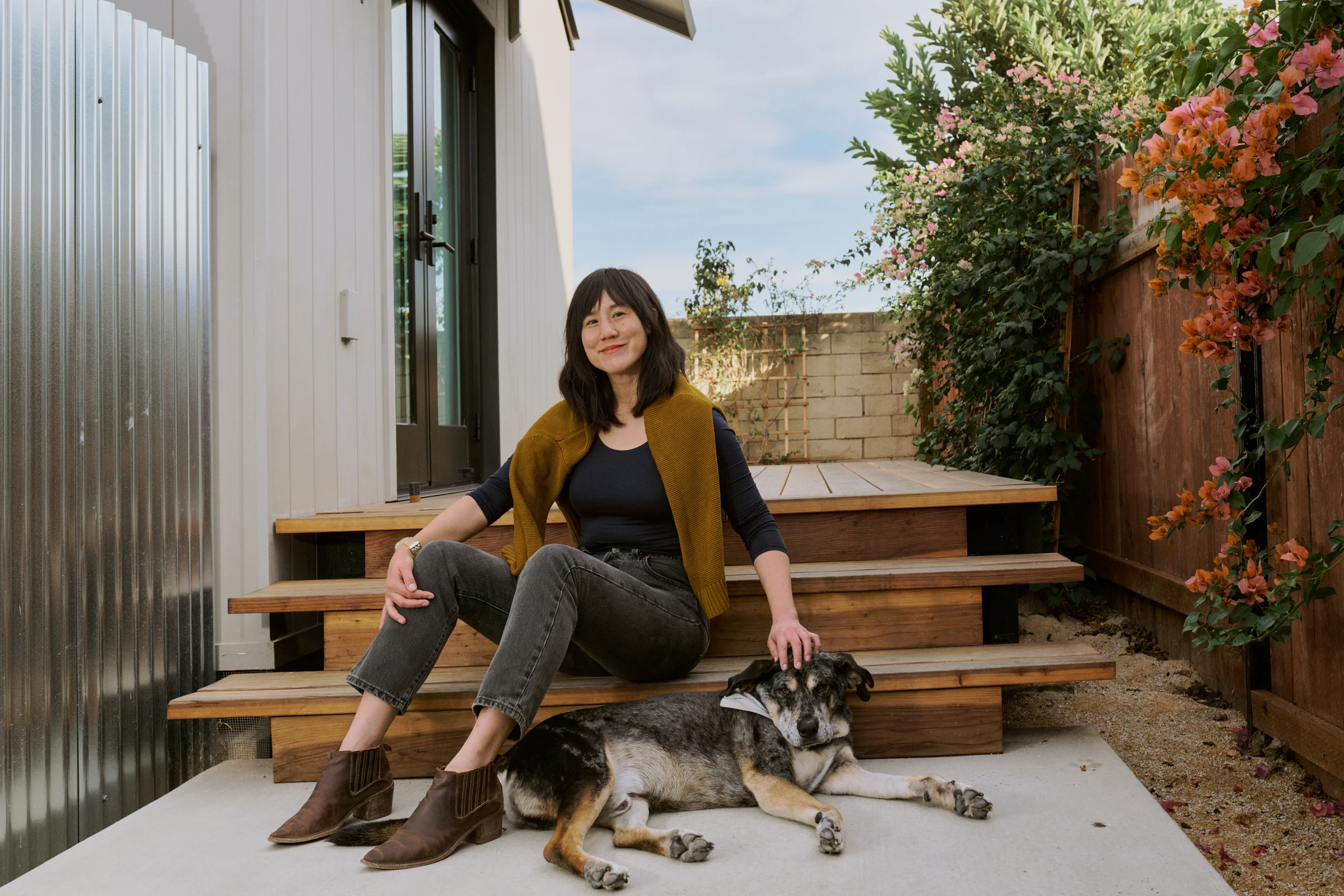Elaine and her tenant's dog, Horace, on the steps of her one bedroom Backyard.