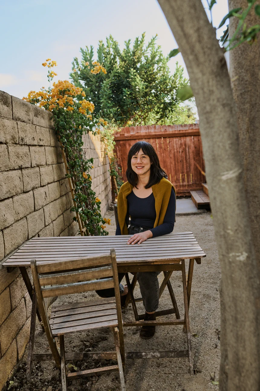 Elaine in the private yard of her rental unit.”
			loading=